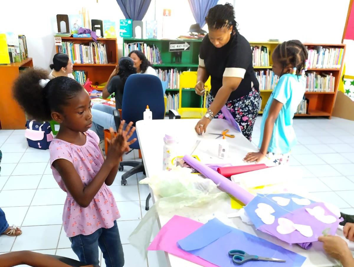 Children and staff at the Belize National Library during a craft workshop